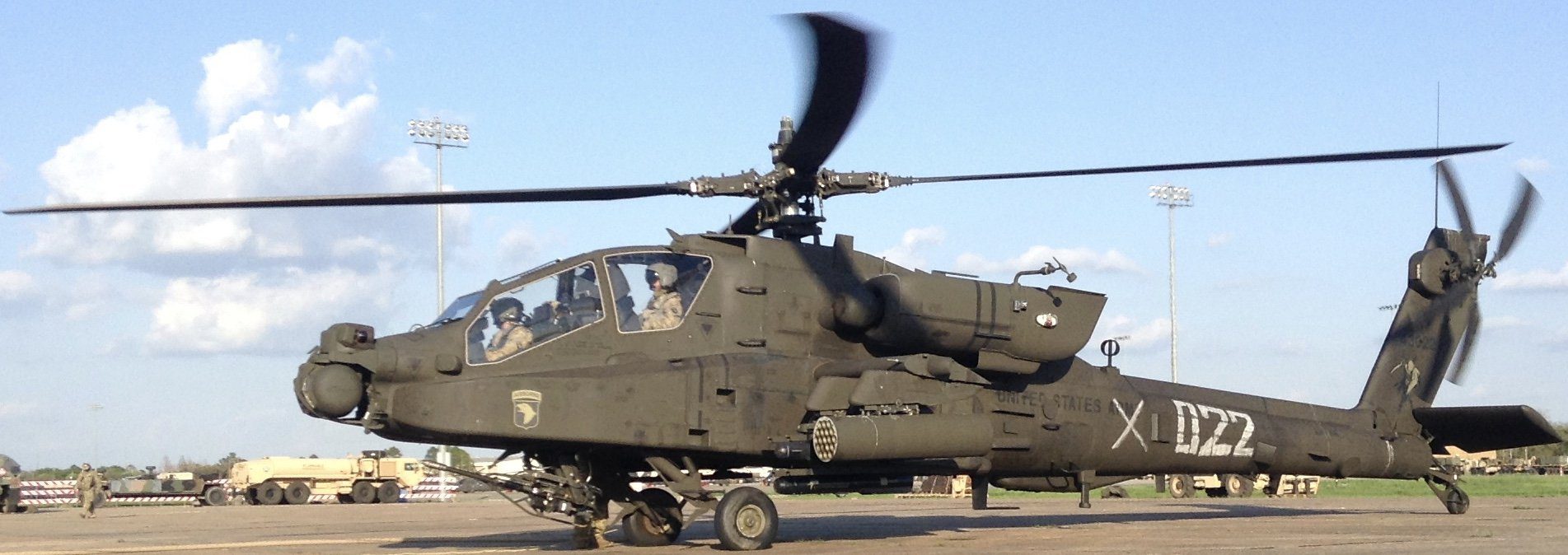 A helicopter with its landing gear down and the cockpit of it.