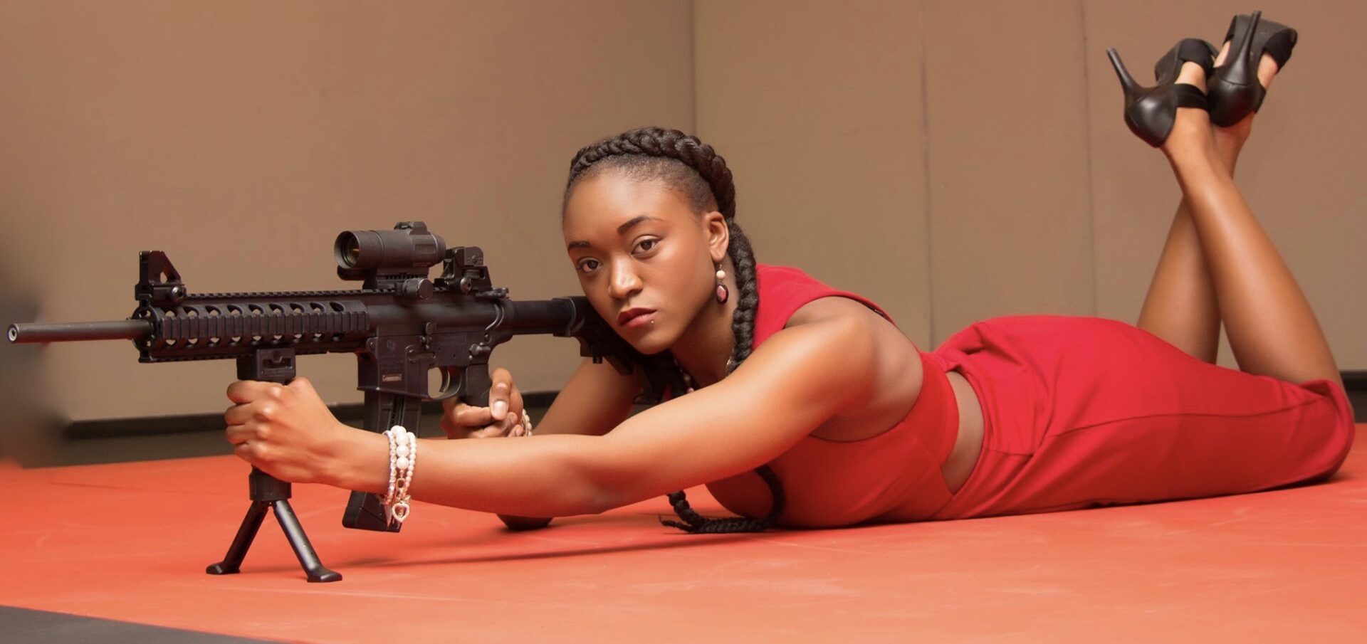 A woman laying on the ground holding a camera.